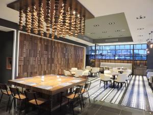 a dining room with a large table and chairs at Hotel N°5 in Kota Kinabalu