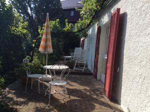 un patio con mesa, sombrilla y sillas en Ferienwohnung Cipolla, en Oberkirch