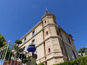 a building with a clock tower on top of it at Château du Grand Jardin in Valensole