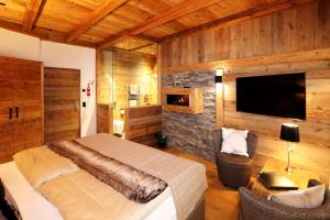 A bed or beds in a room at Amber Ski-in/out Hotel & Spa