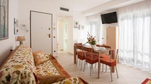 a living room with a table and a dining room at Casavacanze Internazionale in Diano Marina