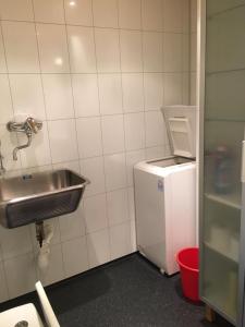 a bathroom with a sink and a small refrigerator at Marifjøra Sjøbuer in Marifjora