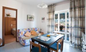 a living room with a table and a couch at Casavacanze Internazionale in Diano Marina