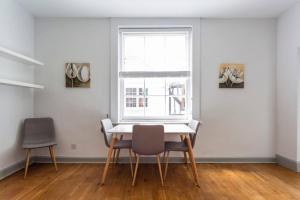 a dining room with a table and two chairs and a window at Spacious Central Chic Apartment - Simplycheckin in Winchester +21 photos