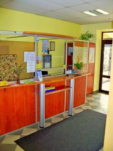 an office with a reception counter with yellow walls at Velga in Vilnius