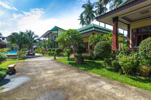 a building with a pathway next to a resort at Sleep In Lanta Resort in Ko Lanta