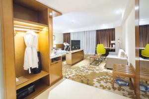 a hotel room with a hotel suite with a room at Ramada Encore Wuhan in Wuhan