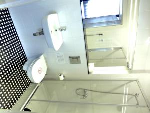 a bathroom with a glass shower and a toilet at 7 Rooms MTP in Poznań