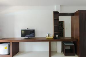 a wooden desk with a computer on top of it at Sleep In Lanta Resort in Ko Lanta