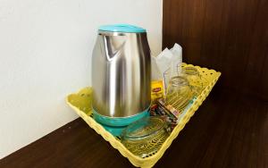 a metal container in a yellow tray on a table at Sleep In Lanta Resort in Ko Lanta