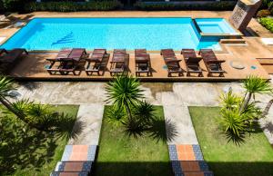 an overhead view of a swimming pool with chairs and a swimming pool at Sleep In Lanta Resort in Ko Lanta