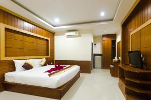 a bedroom with a large bed and a television at Sleep In Lanta Resort in Ko Lanta
