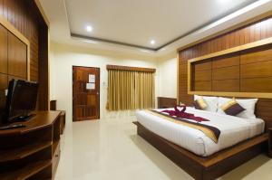 a bedroom with a large bed and a television at Sleep In Lanta Resort in Ko Lanta