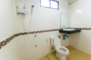 a bathroom with a toilet and a shower at Sleep In Lanta Resort in Ko Lanta