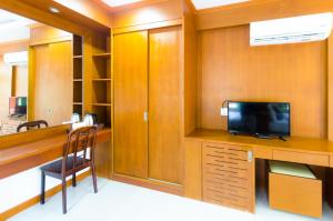 a office with a desk with a tv and a chair at Sleep In Lanta Resort in Ko Lanta