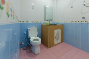 a bathroom with a toilet and a mirror and blue tiles at Sleep In Lanta Resort in Ko Lanta