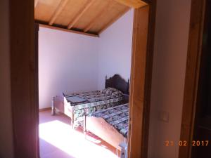 a small bedroom with a bed in a room at Casa do Forno, Viseu in Oliveira de Barreiros