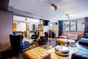 a large living room with couches and chairs at Sunny Hills Ski&Wellness in Pamporovo