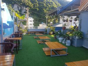 a row of tables and chairs on a patio at Luna's House Hostel in Cat Ba
