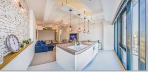 a kitchen and living room with a large window at LOFT Astoria in Budapest