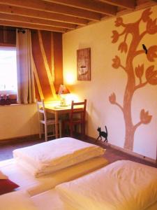 a bedroom with a bed and a tree mural on the wall at Arrest-en-Baie in Arrest