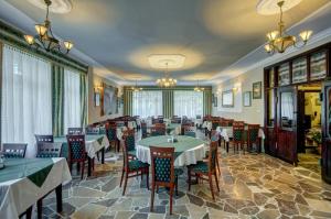 a restaurant with tables and chairs in a room at Willa Roztoka in Zakopane