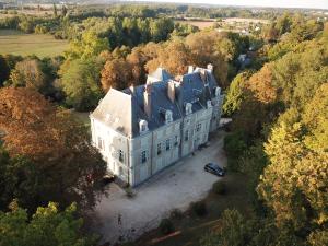 an aerial view of a large white house with a blue roof at Gîte de Charme 5 pers. in Saint-Gervais-la-Forêt