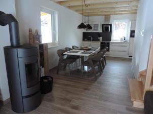 a living room with a fireplace and a table and chairs at KWO-villa Sonnenglück in Arnoldstein