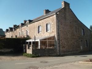 a large brick building with a large window at Gîte des bords de Rance in Langrolay