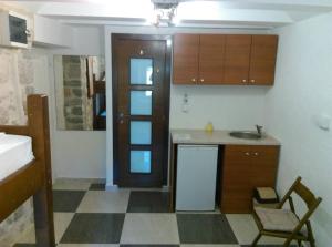 a small kitchen with a sink and a counter at Apartments Bella in Kotor