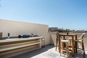 a patio with a table and chairs on a balcony at Soul of Jaffa's Flea Market by Five Stay in Tel Aviv