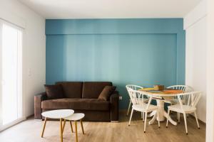 a living room with a couch and a table and chairs at Comfort Zone Apartment in the heart of Athens in Athens