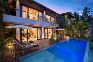 a villa with a swimming pool and a house at Samsara Ubud in Ubud