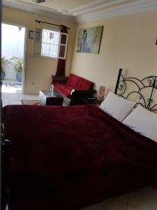 a bedroom with a large bed and a couch at Riad Marlinea in Sale