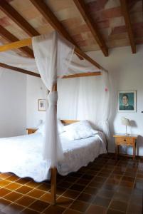 a bedroom with a bed with a canopy at Can Petrel in Pollença