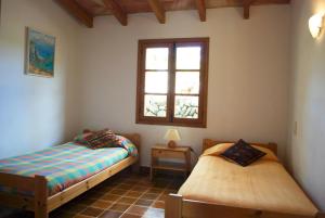 a bedroom with two beds and a window at Can Petrel in Pollença