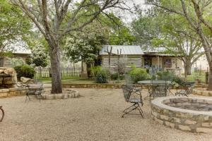 a patio with chairs and a table in a yard at Historic Rocky Hill in Fredericksburg