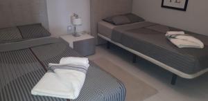 two beds in a small room with two beds sidx sidx sidx at 4daughters Secreto de la Zenia in Playas de Orihuela +21 photos