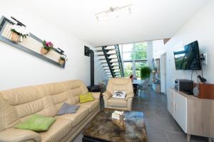 a living room with a couch and a table at Gite Des Peupliers in Girondelle