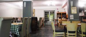 a dining room with tables and chairs in a restaurant at Le FLORIDA in Zicavo +5 photos
