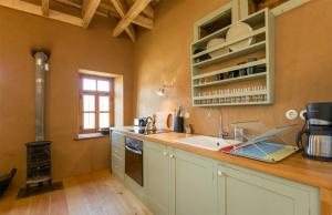 a kitchen with a sink and a stove at Serene Stone House in Oxiá