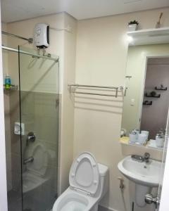 a bathroom with a shower and a toilet and a sink at Cozy Studio Unit at Davao City Downtown Area in Davao City