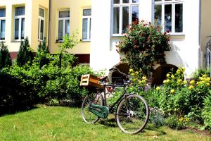 a bike parked in the grass in front of a house at The Avalon Hotel - Altstadt Schwerin in Schwerin