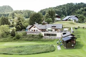 an aerial view of a house on a golf course at Garni Haus Sonnleitn - Adults only in Fuschl am See