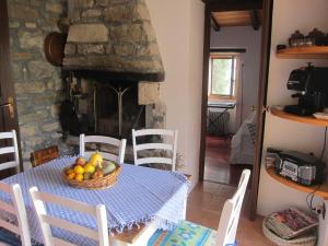 a table with a basket of fruit on it with a fireplace at Villa Bella in Grožnjan
