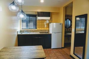 a kitchen with a white refrigerator and a table at Casa Bella Inn Downtown LA in Los Angeles +26 photos