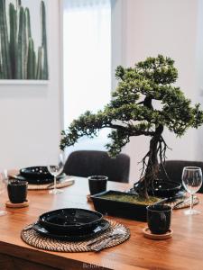 a bonsai tree sitting on top of a wooden table at 23 Degree Khaoyai 2 Bedroom Tropical style in Ban Huai Sok Noi