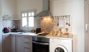 a kitchen with a sink and a dishwasher at Villa Itis Luxury Suite with Balcony, Panoramic View & Jacuzzi in Neapoli Voion