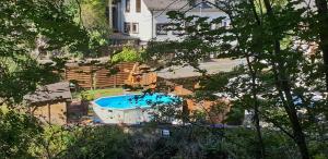 an overhead view of a swimming pool in front of a house at Hotel Elfenmühle in Bad Bertrich