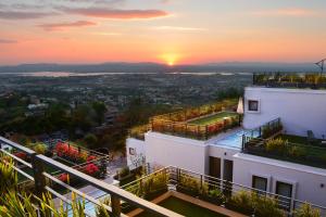 a sunset view from the balcony of a building at Ilo Rojo San Miguel de Allende Curamoria Collection in San Miguel de Allende